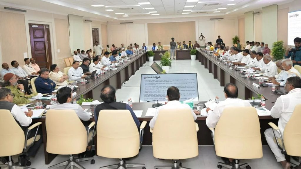 Large formal meeting with officials seated around long conference table in a government briefing room.
