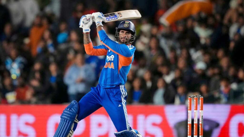 Cricketer in blue India kit batting shot during match.