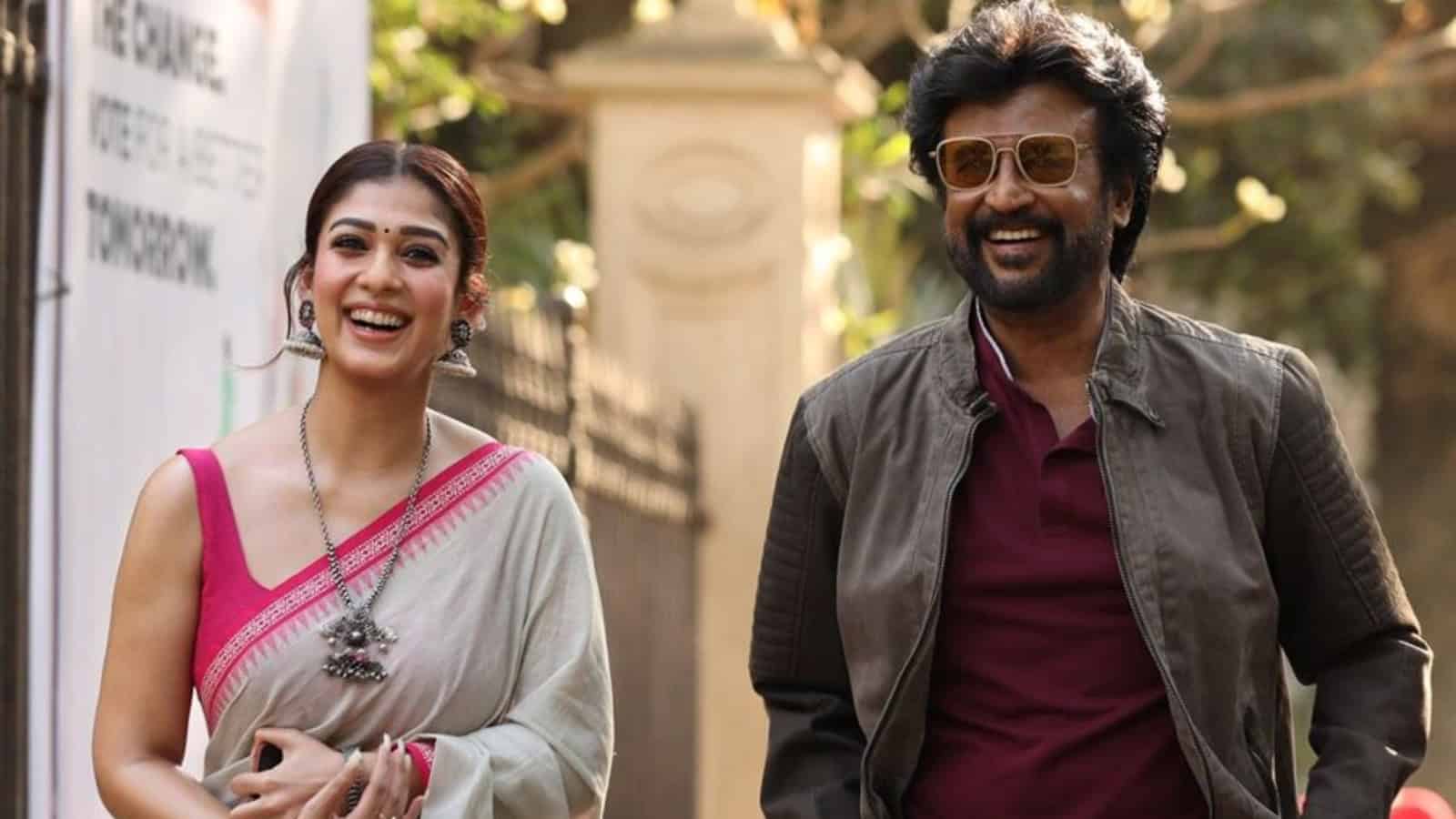 Nayanthara-like actress in pink saree walking with a man in sunglasses and brown jacket.